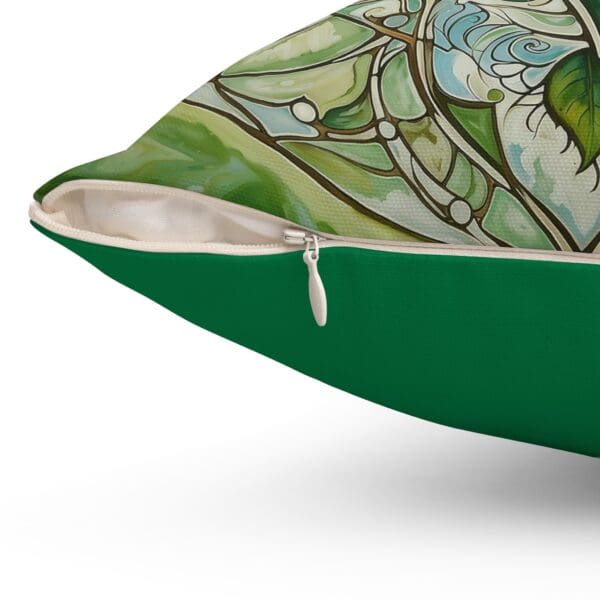 A close up of the green pillow with a floral design