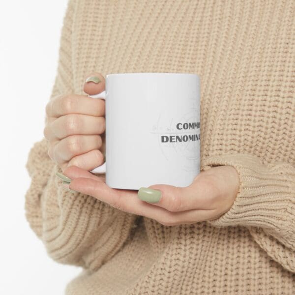 A person holding a coffee mug in their hands.