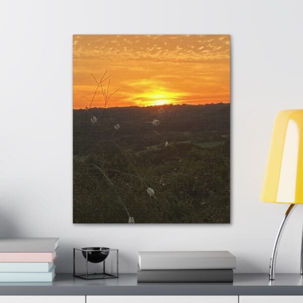 A painting of the sun setting over a field