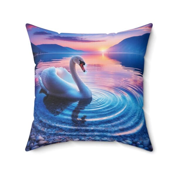 A swan swimming in the water at sunset.