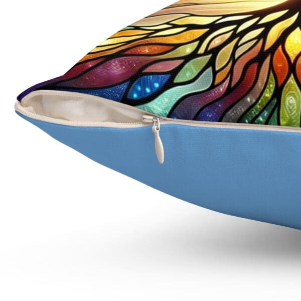 A close up of the colorful stained glass design on a pillow.