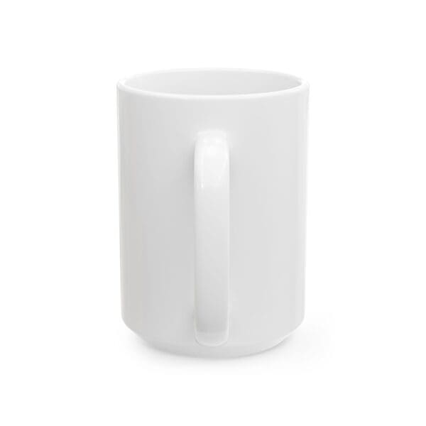 A white coffee mug with a handle on top of it.