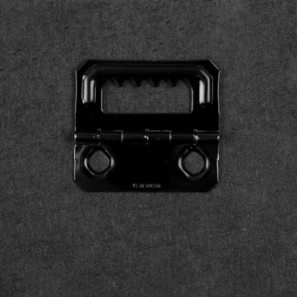 A black plastic object is shown on the ground.