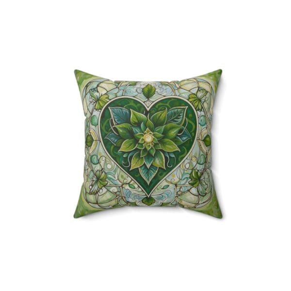 A green heart pillow with flowers and leaves.