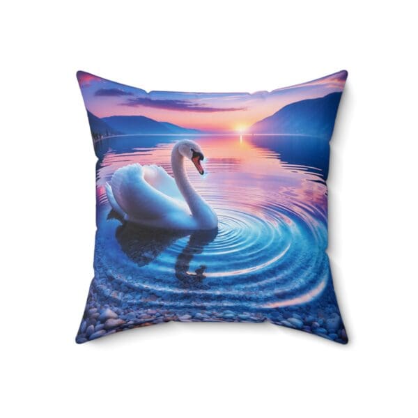 A swan swimming in the water at sunset.